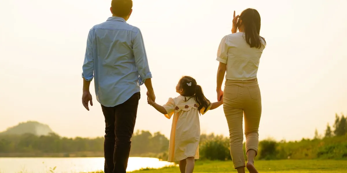 Familia feliz agarrados de la mano paseando Familia feliz agarrados de la mano paseando