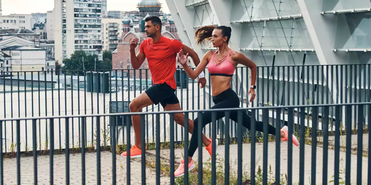 Couple running through an urban park
