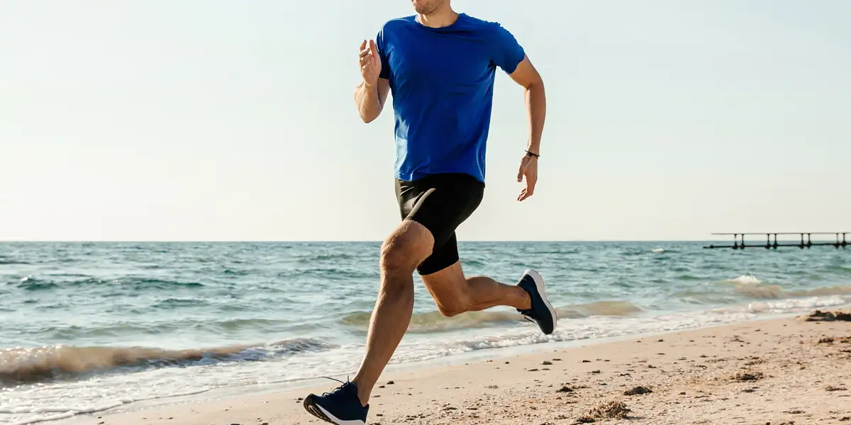 Atleta corriendo por playa