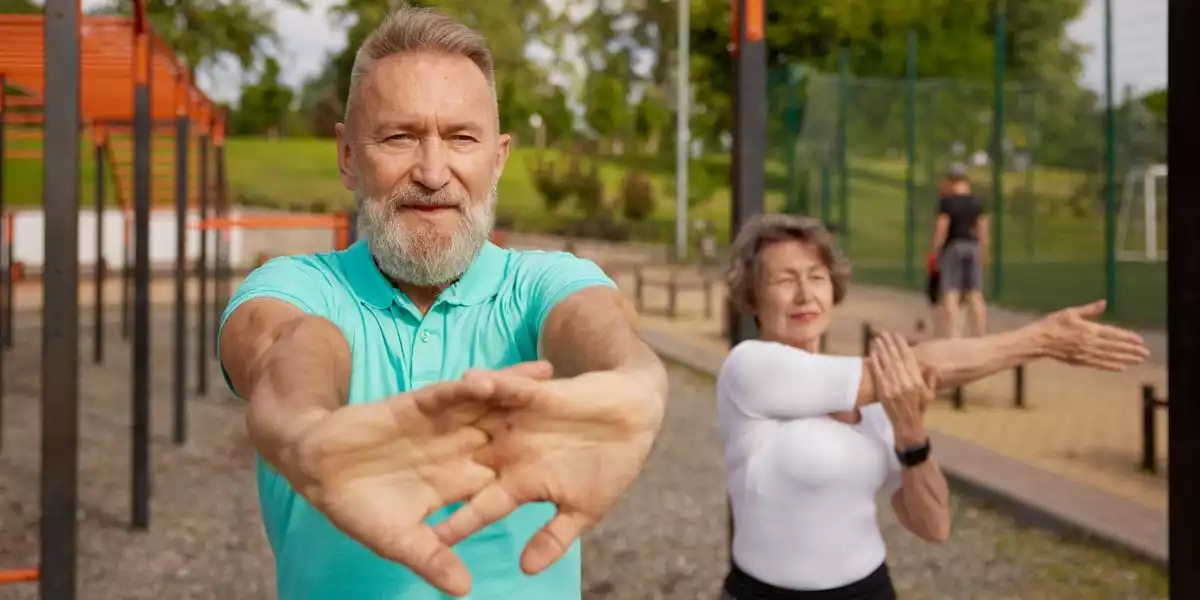 Older couple exercising outdoors in a park