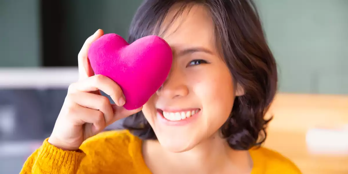 Happy woman with a plush heart Happy woman with a plush heart